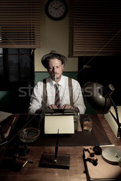 Repórter trabalhando tarde noite fumador escritório Foto stock © stokkete