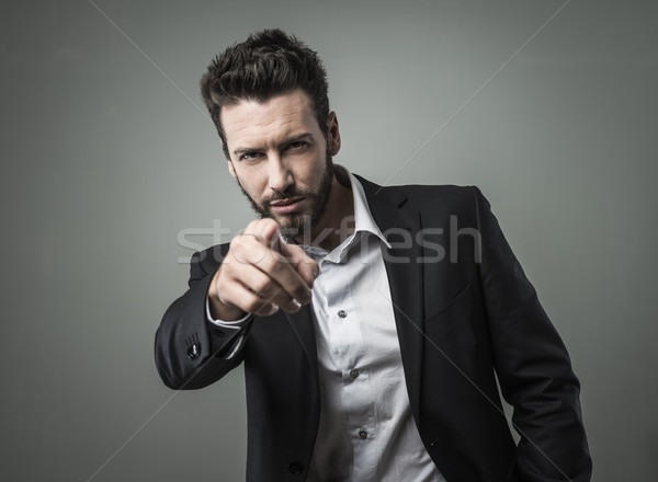 Confident businessman pointing Stock photo © stokkete