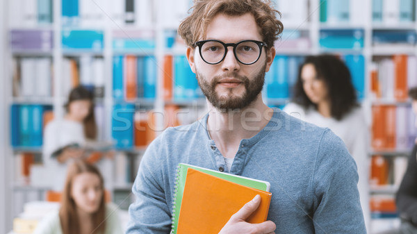 Hipster university student holding notebooks Stock photo © stokkete