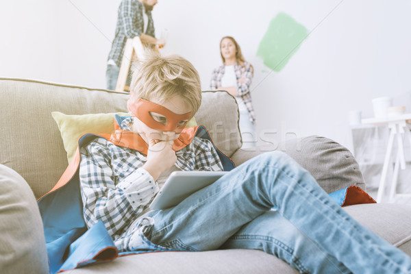Superhero using a tablet and home makeover Stock photo © stokkete