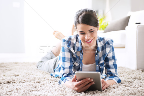 Relaxing in the living room with tablet Stock photo © stokkete
