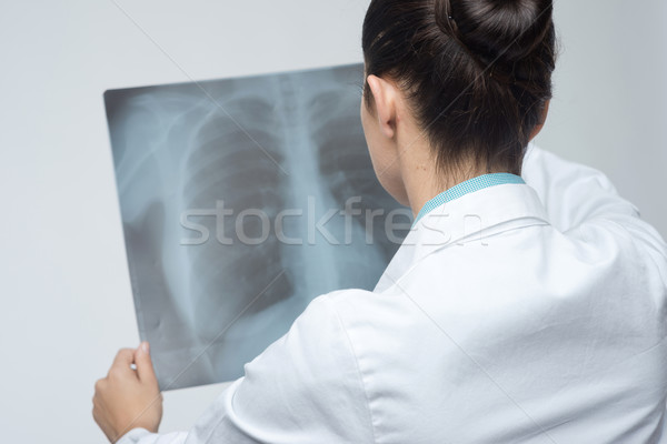 Female doctor examining x-ray image Stock photo © stokkete