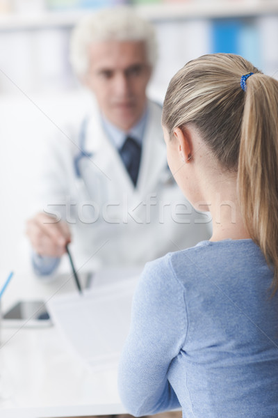 Doctor showing medical records to the patient Stock photo © stokkete