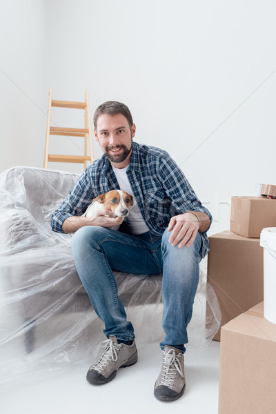 Dog owner in his new house Stock photo © stokkete