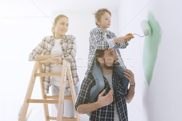 Family painting walls together Stock photo © stokkete