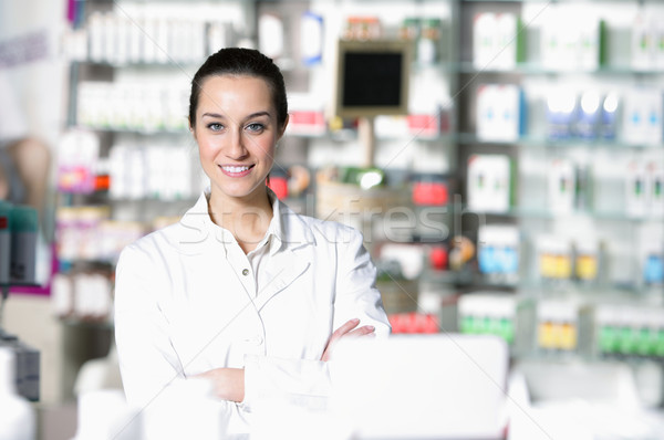 Stock photo: portrait of young healthcare worker and background pharmacy.