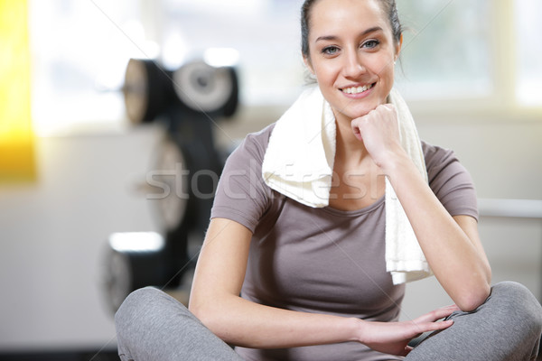 young woman sitting on the gym's floor after workout Stock photo © stokkete