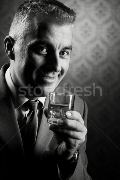 Vintage businessman holding a glass of whisky Stock photo © stokkete
