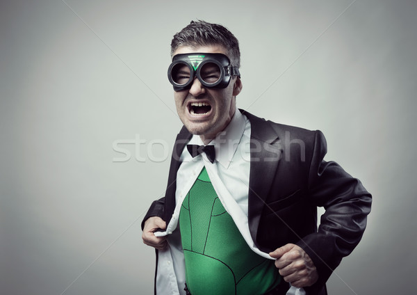 Superhero taking off shirt and jacket Stock photo © stokkete