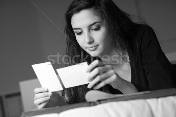 Woman filling a photo album Stock photo © stokkete