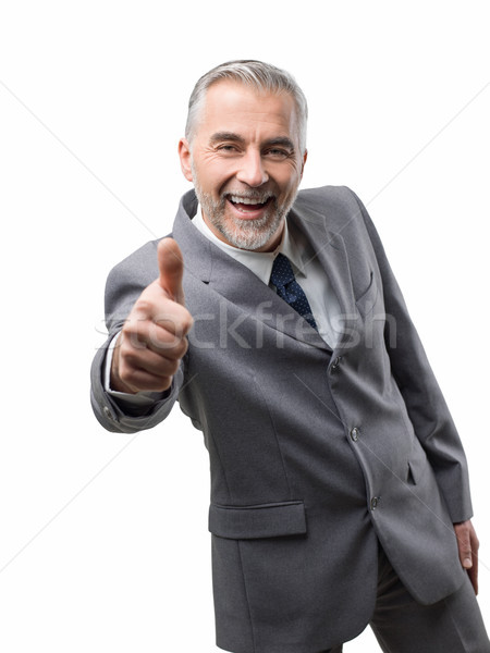 Stock photo: Confident business executive giving a thumbs up