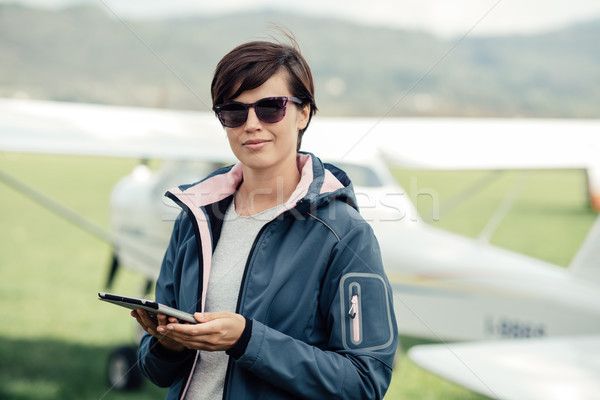 Female pilot using a tablet Stock photo © stokkete