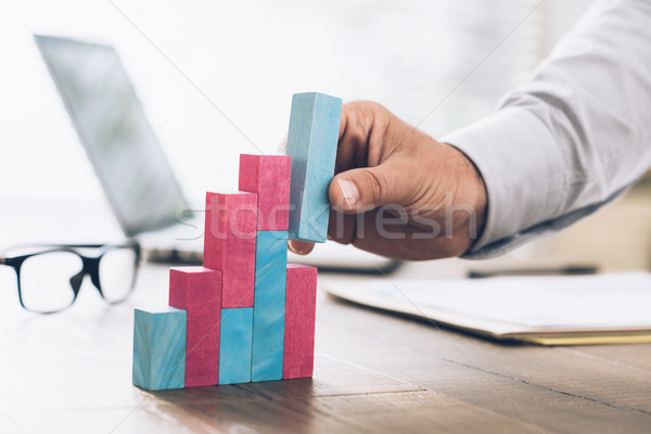 Businessman building a successful financial graph Stock photo © stokkete