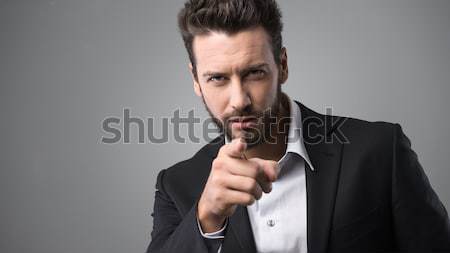 Confident businessman pointing Stock photo © stokkete
