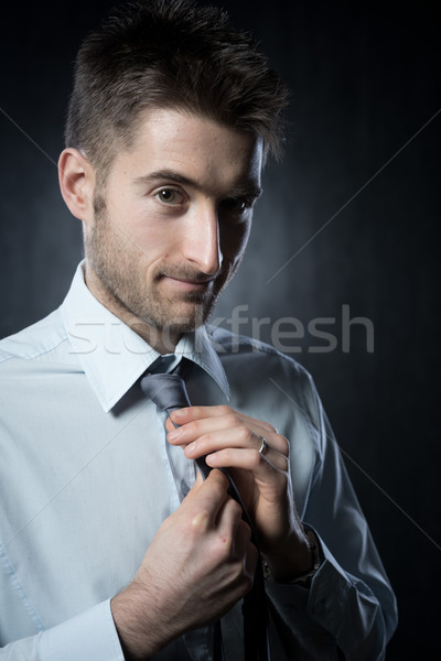 Stock photo: Adjusting necktie