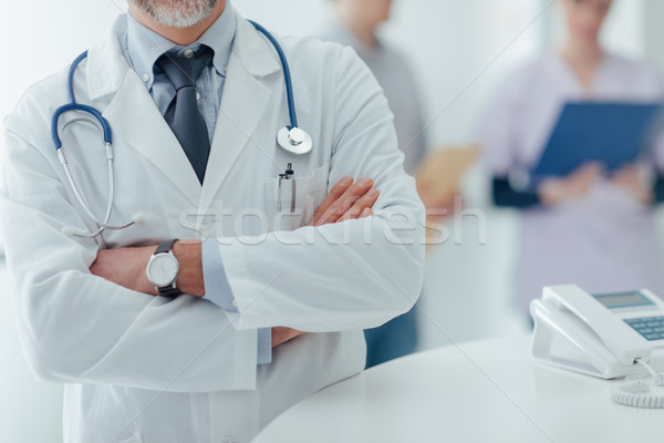 Confident doctor at the reception desk Stock photo © stokkete