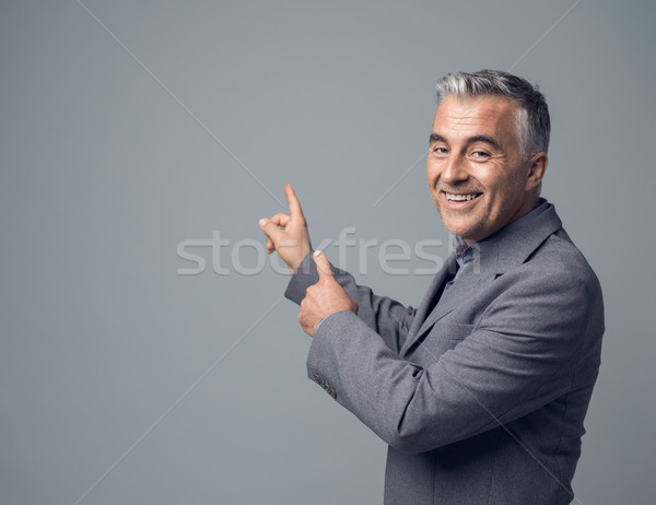 Businessman pointing at blank copyspace Stock photo © stokkete