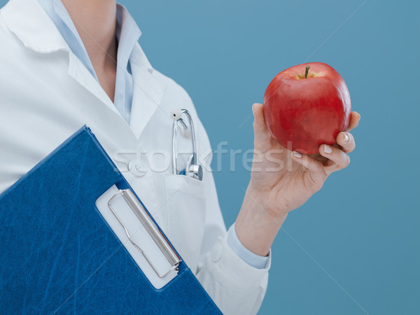 Professional nutritionist holding an apple Stock photo © stokkete