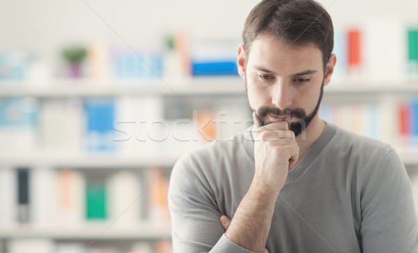Confident man with hand on chin Stock photo © stokkete