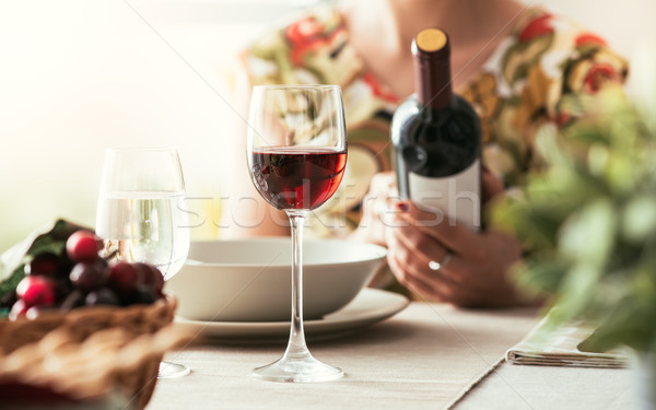 Stock photo: Woman reading a wine label