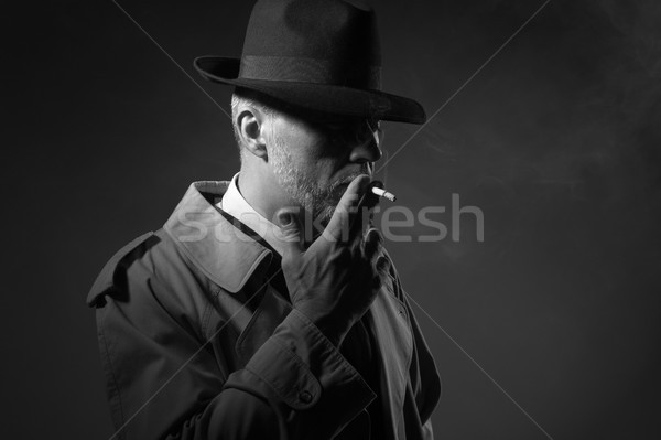 Uomo fumare sigaretta elegante vecchio stile buio Foto d'archivio © stokkete