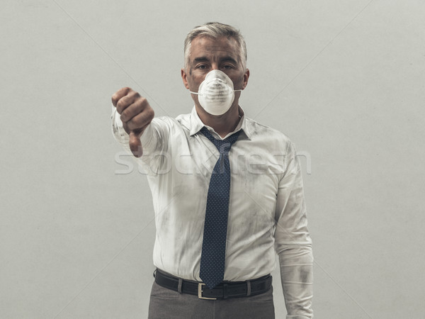 Businessman with pollution mask Stock photo © stokkete