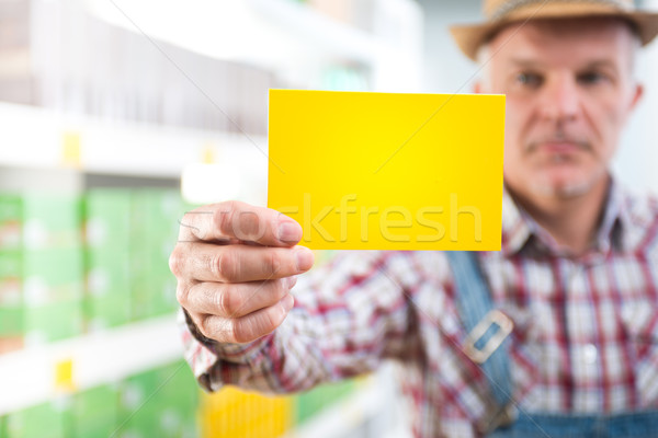 Farmer with sign at supermarket Stock photo © stokkete