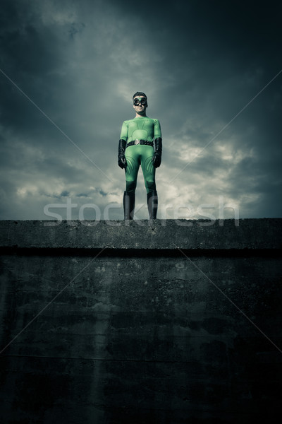 Stock photo: Superhero standing on a concrete wall