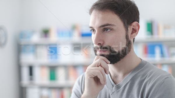Confident man with hand on chin Stock photo © stokkete