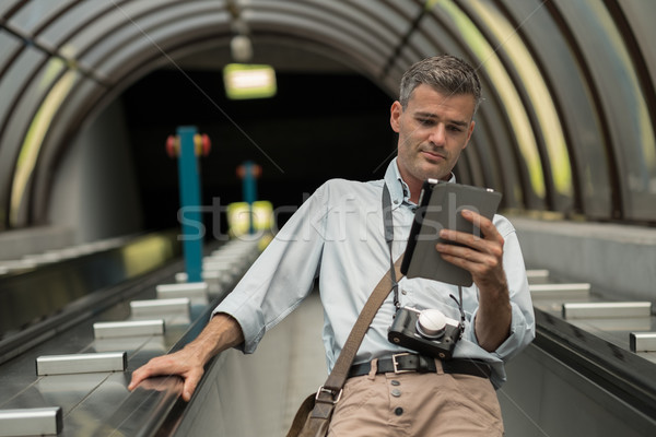 Man with tablet on the escalator Stock photo © stokkete