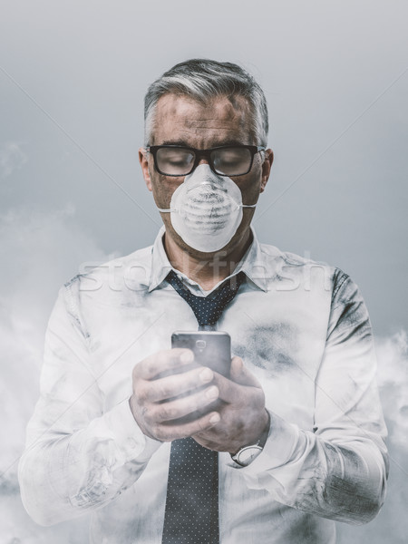 Stock photo: Businessman having a phone call and toxic smog