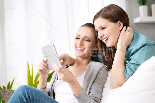 Smiling girls with tablet Stock photo © stokkete