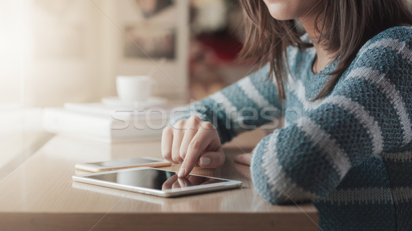 Young woman at the bar using a tablet Stock photo © stokkete