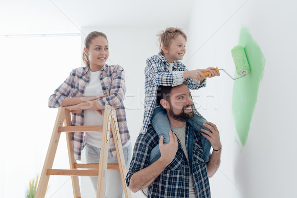 Stock photo: Family painting walls together