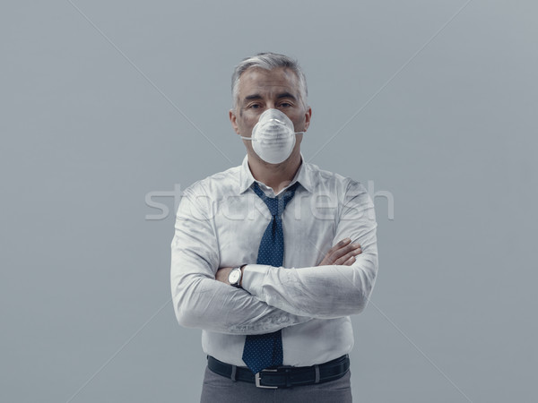 Businessman with pollution mask Stock photo © stokkete