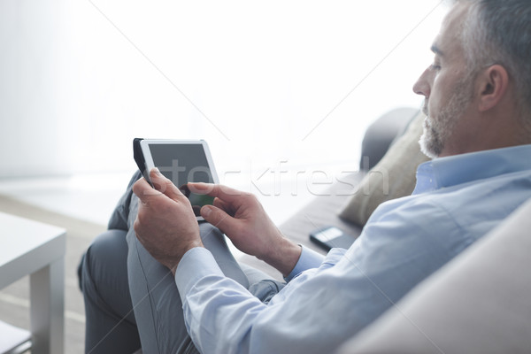 Man using a digital tablet Stock photo © stokkete