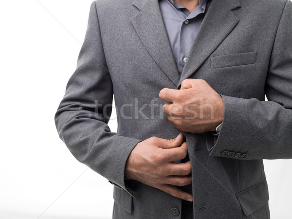 Businessman unbuttoning his jacket Stock photo © stokkete