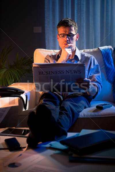 Om de afaceri lectură ziar tarziu noapte financiar Imagine de stoc © stokkete