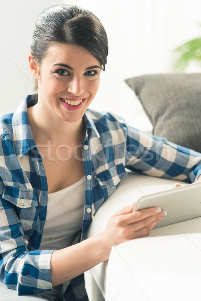 Relaxing in the living room with tablet Stock photo © stokkete