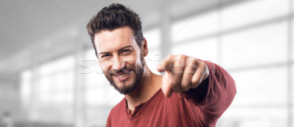 Smiling man pointing at camera Stock photo © stokkete