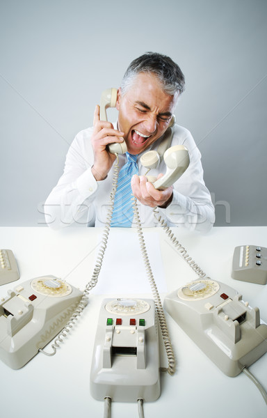 Businessman yelling into phone Stock photo © stokkete