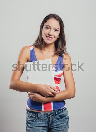 Smiling girl holding a book Stock photo © stokkete