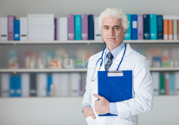 Doctor checking medical records Stock photo © stokkete