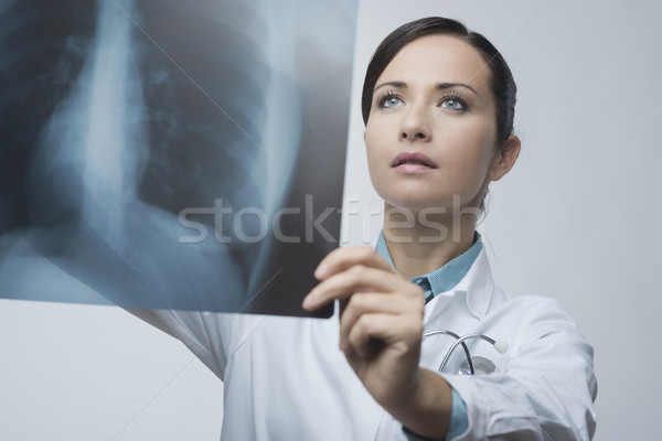 Female doctor examining x-ray image Stock photo © stokkete