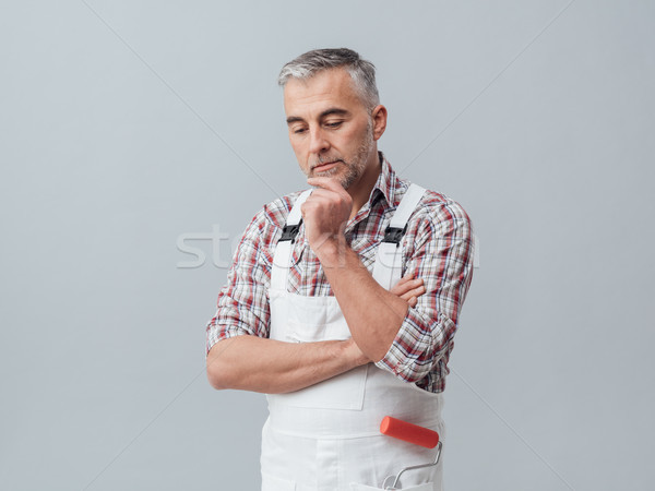 Pensive painter with hand on chin Stock photo © stokkete