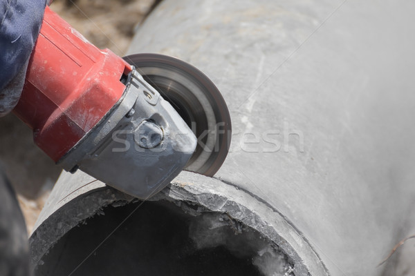 Plumbers cutting concrete water pipes Stock photo © stoonn