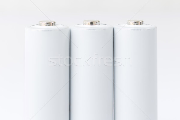 AA batteries over white Stock photo © stoonn