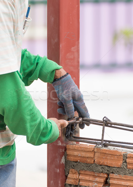 Workers using steel wire and pincers rebar before concrete is po Stock photo © stoonn
