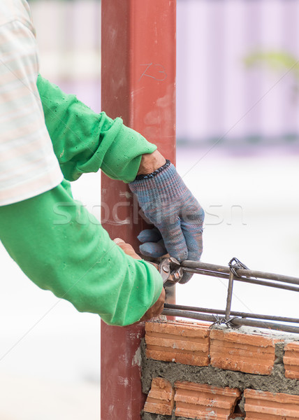 Workers using steel wire and pincers rebar before concrete is po Stock photo © stoonn