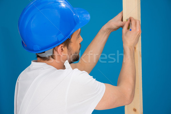 Carpenter or joiner marking a measurement Stock photo © stryjek